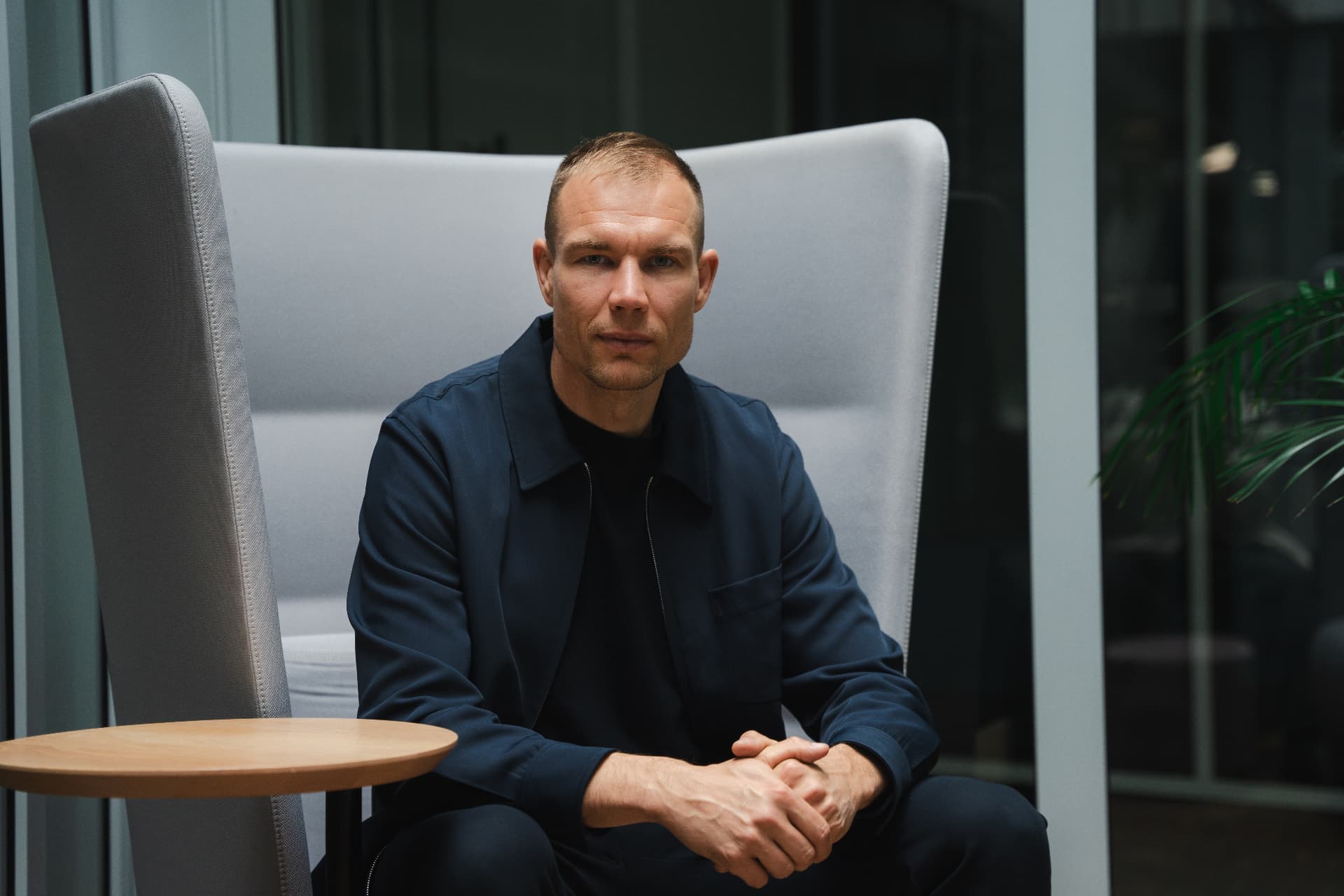 Holger Badstuber seated in a high-backed grey chair